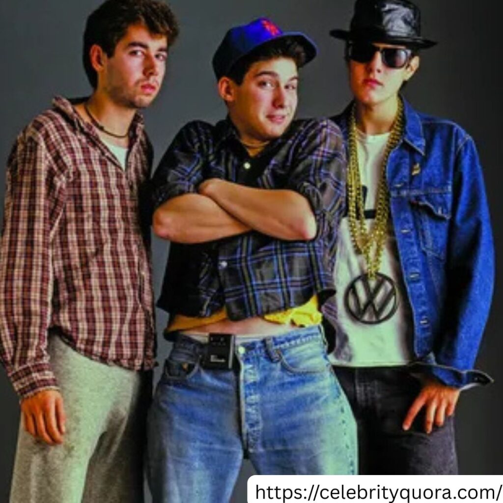The Beastie Boys, including Ad-Rock, are shown in a posed shot.