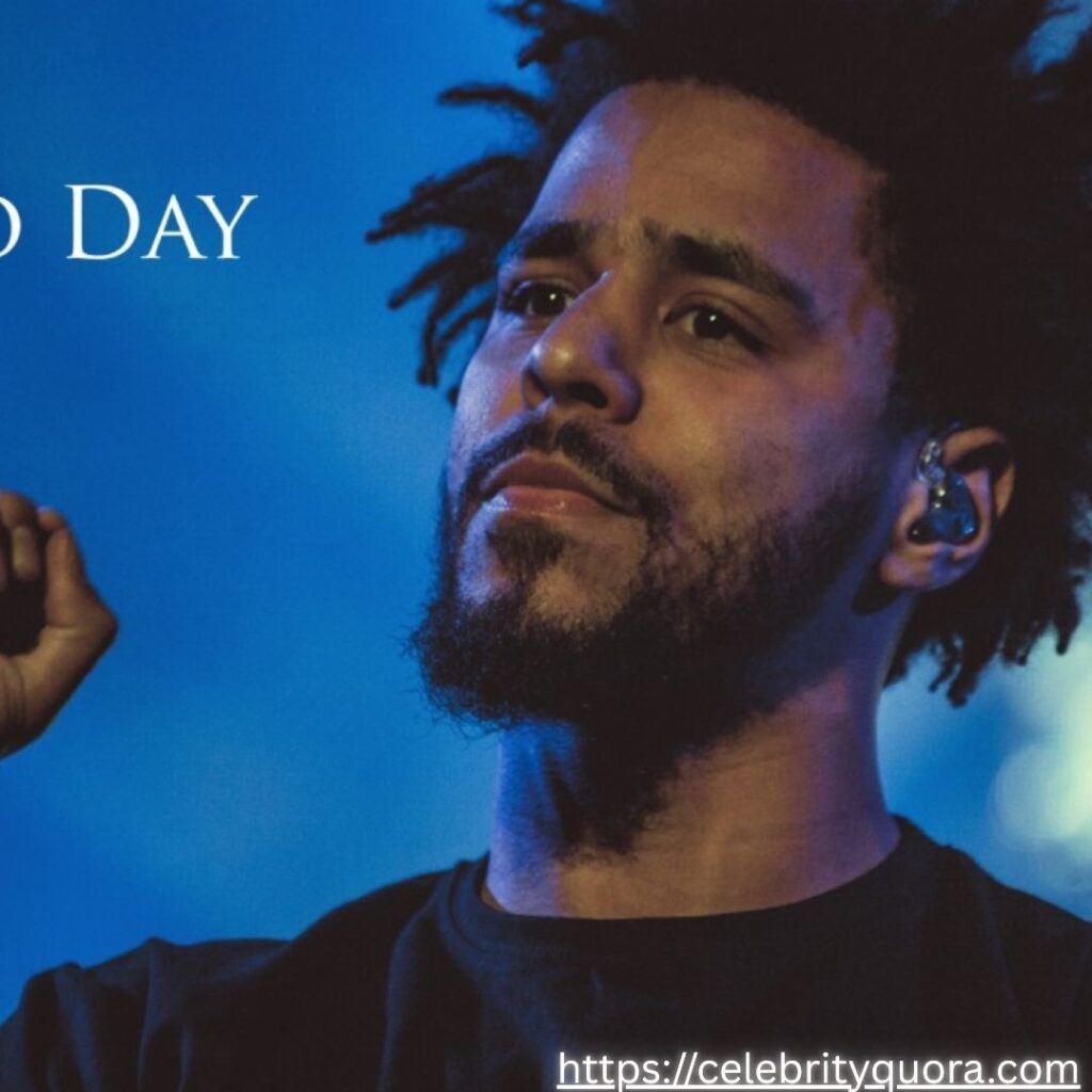  A close-up of J. Cole with a microphone in his hand, with text overlaying the image that says 'J. Cole' and 'Day to Day'.