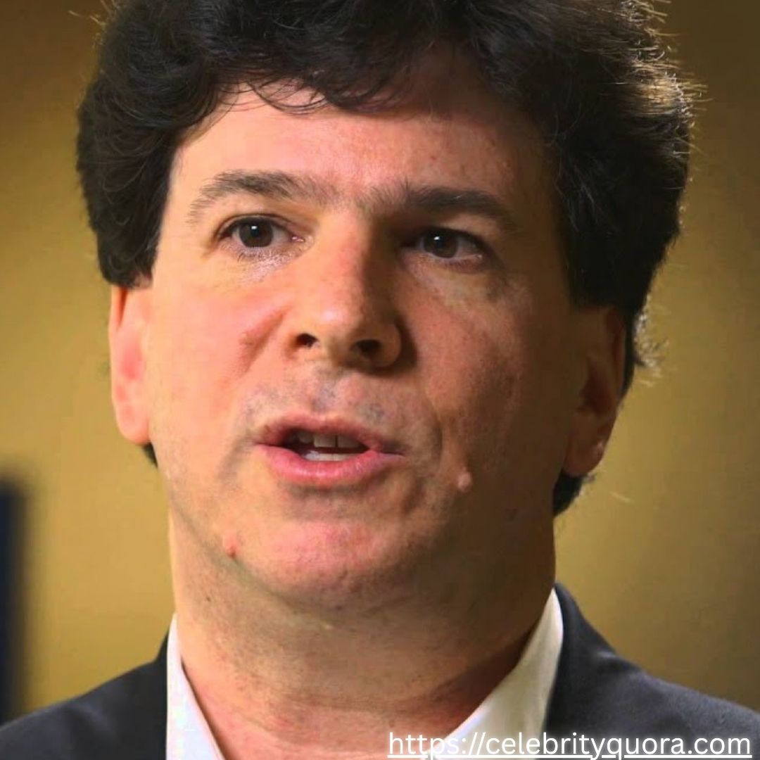 Purple Gradients Beauty and Skincare Product Feature Instagram Post (22) Close-up portrait of Eric Weinstein, a man with dark, curly hair and a serious gaze directed slightly off-camera. He is dressed in a dark suit and appears to be in the midst of speaking.