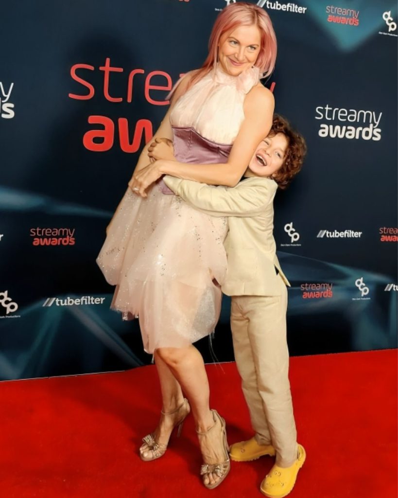 Max Alexander hugging his mother on a red carpet at the Streamy Awards.