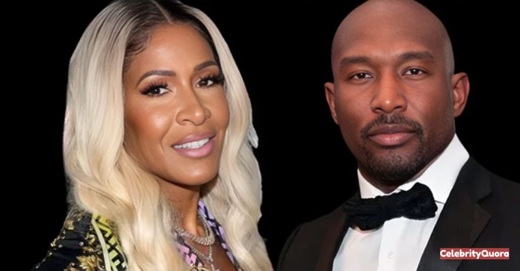 A close-up photo of reality TV stars Shereé Whitfield and Martell Holt. Shereé is on the left, smiling with long blonde hair and wearing a colorful patterned top. Martell is on the right in a black tuxedo, looking directly at the camera.